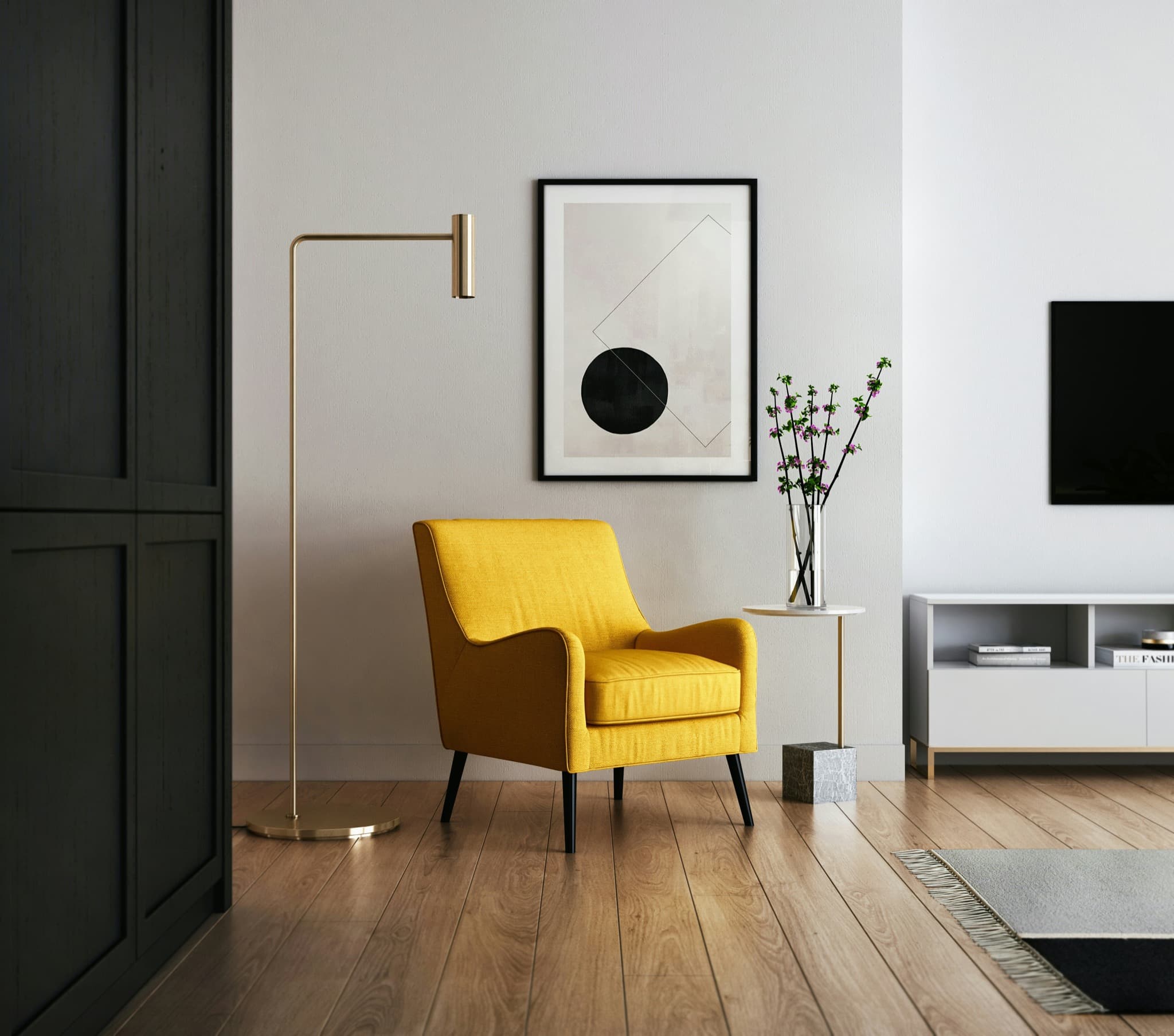 Quiet interior with a yellow chair, wood flooring, floor lamp, and framed artwork